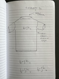 a notebook with a drawing of a t - shirt